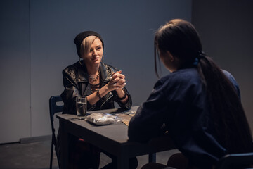Fototapeta na wymiar An investigator interrogates a suspected drug dealer in an interrogation room.