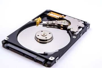 Internal parts of a hard disk isolated on a white background. Close up of Hard disk drive inside view.