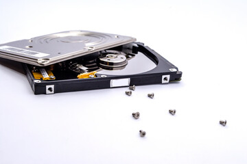 Internal parts of a hard disk isolated on a white background. Close up of Hard disk drive inside...