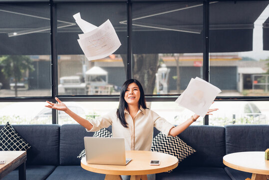 Lifestyle freelance business woman and laptop computer he has throwing document after success the job in coffee shop