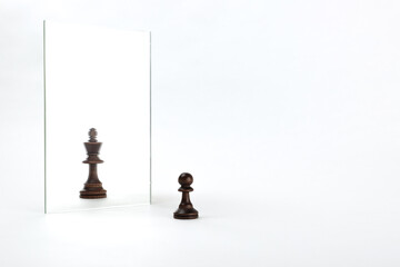 the pawn sees itself in the mirror as a king