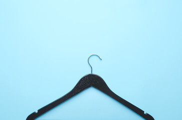 Clothes hanger on color background