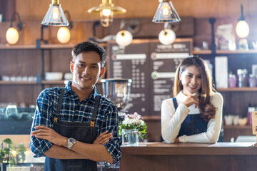 Portrait of Asian Young Small business owner with coffee shop in front of counter bar, entrepreneur and startup, preparing for service to customer in cafe store and restaurant,business partner concept
