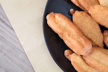 A plate of fried golden fried dough sticks