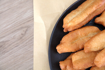 A plate of fried golden fried dough sticks