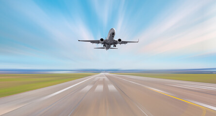 Fototapeta na wymiar Airplane in motion- White Passenger plane fly up over take-off runway from airport 