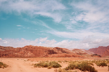 Rock mountains in dessert with blue sky and cloud in Xinjian, China.