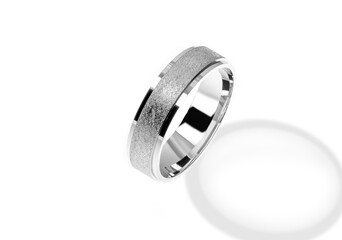 Golden wedding ring on a white background.