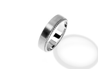 Golden wedding ring on a white background.