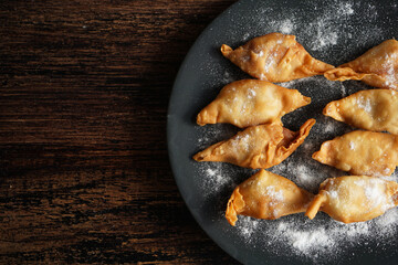 Banana snack from Indonesia called `Molen` or `Pisang Molen`. Bananas are wrapped in flour dough and then fried before serving. Molen are served with powdered sugar for sweetening.
