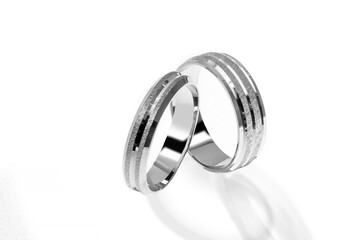 Golden wedding ring on a white background.