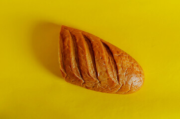 Half a loaf of bread on a yellow background.