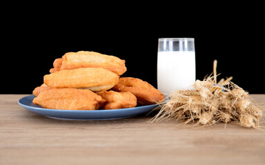 Breakfast fritters, milk and a handful of wheat ears