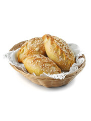 food photography of traditional homemade stuffed baked patties or pies in a wooden plate side view. Baked Russian pies made of yeast dough in a rustic style on white background close up