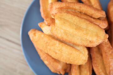 Looking down and shooting a plate of fried dough sticks