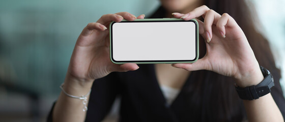 Businesswoman showing horizontal smartphone include clipping path