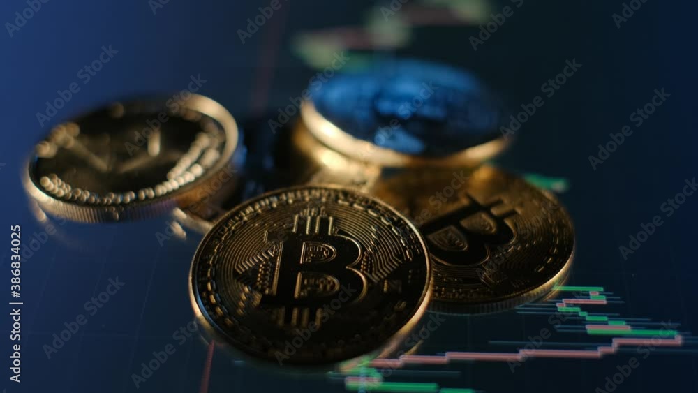 Poster bitcoin gold coins and defocused chart background. virtual cryptocurrency concept. bitcoins on ladde
