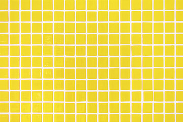 Square yellow ceramic tiles texture. Trendy interior background pattern. 2021 color trend.
