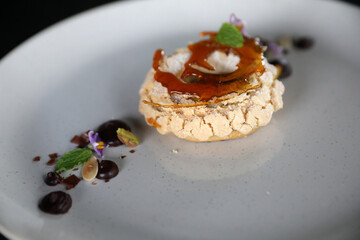 Chocolate dessert cake with berry sauce and almond with decorated