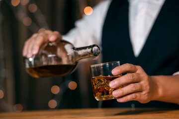 Barman pouring whiskey whiskey glass beautiful night