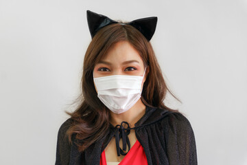 women in halloween witch costume wearing protective face mask