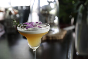 Pink Cocktail glass with ice at a bar counter