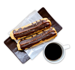 éclair, an oblong pastry made with choux dough filled with a cream and topped with chocolate icing. filled with a vanilla flavoured custard isolated on white background