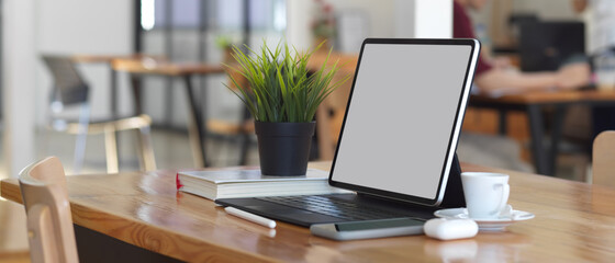 Digital tablet with accessories include clipping path on wooden table