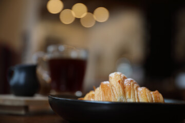 croissant with coffee close up on wood background