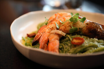 spaghetti pesto sauce with grilled shrimps italian food