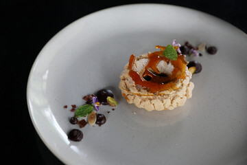 Chocolate dessert cake with berry sauce and almond with decorated