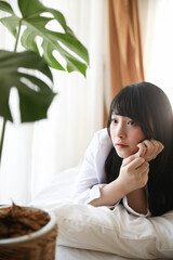 Portrait beautiful asian girl sleeping on bed in white room