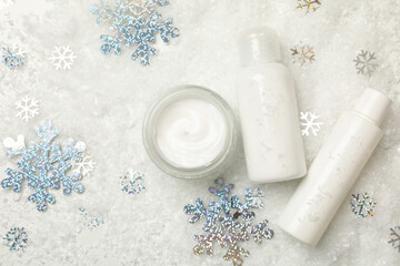 Fototapeta na wymiar Cosmetics on white background with decorative snow