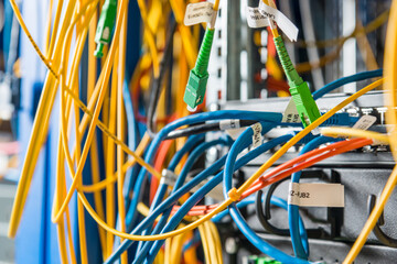 detail of server rack with fiber optic cables attached to front