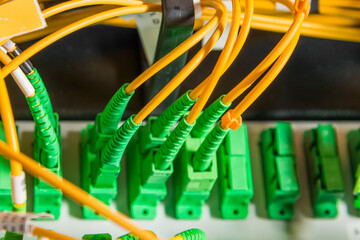 detail of server rack with fiber optic cables attached to front