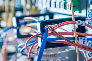 detail of server rack with fiber optic cables attached to front