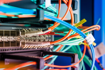 detail of server rack with fiber optic cables attached to front
