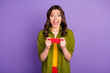 Obraz premium Portrait of crazy astonished girl use smartphone play video social media games impressed fast speed connection scream wow omg wear good look clothes isolated purple color background