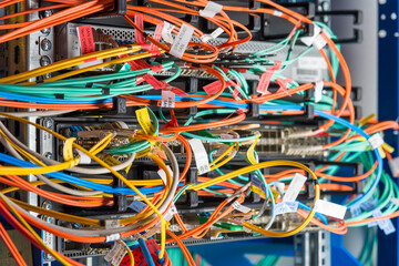 detail of server rack with fiber optic cables attached to front