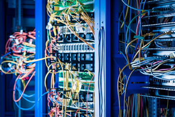 detail of server rack with fiber optic cables attached to switch