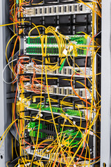 detail of server rack with fiber optic cables attached to front