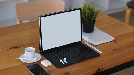 Wooden table with tablet, smartphone, accessories and book, include clipping path