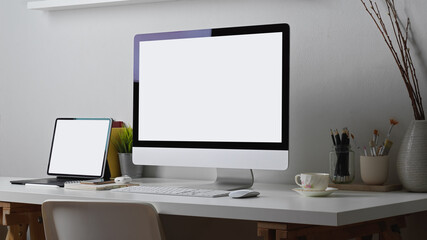 Home office desk with computer, tablet, supplies and decoration, include clipping path