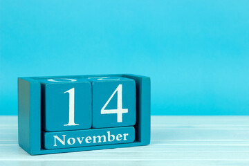 wooden calendar with the date of November 14 on a blue wooden background, International Day of Speech Therapist