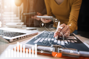 Businessmen team or financial data analysts working with tablets and laptop computers and data...
