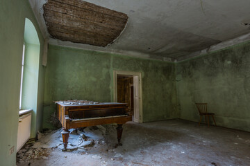 old piano with collapsed ceiling from a green room