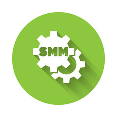 White SMM icon isolated with long shadow. Social media marketing, analysis, advertising strategy development. Green circle button. Vector.