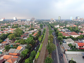 Obraz premium Aerial drone view of KRL commuter line Jabodetabek JR205 electric train near Pasar Minggu, Jakarta, Indonesia