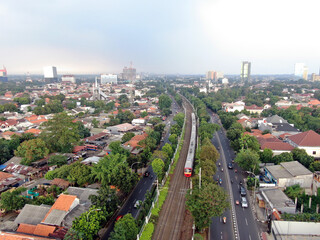 Aerial drone view of KRL commuter line Jabodetabek JR205 electric train near Pasar Minggu, Jakarta, Indonesia