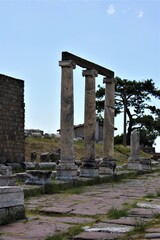 Fototapeta premium Theatre of The Asclepion of Pergamon Ancient City. Bergama, Izmir, Turkey. Relics, Roman columns, gates during sunny day and blue sky.